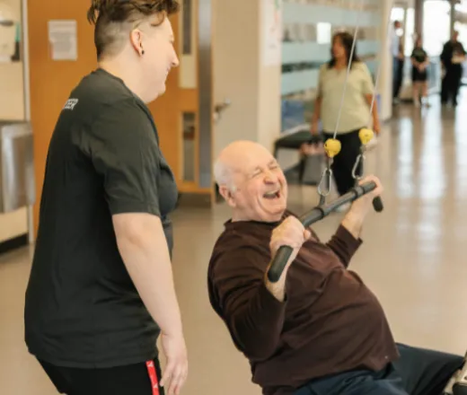 Senior working out with YMCA Staff member