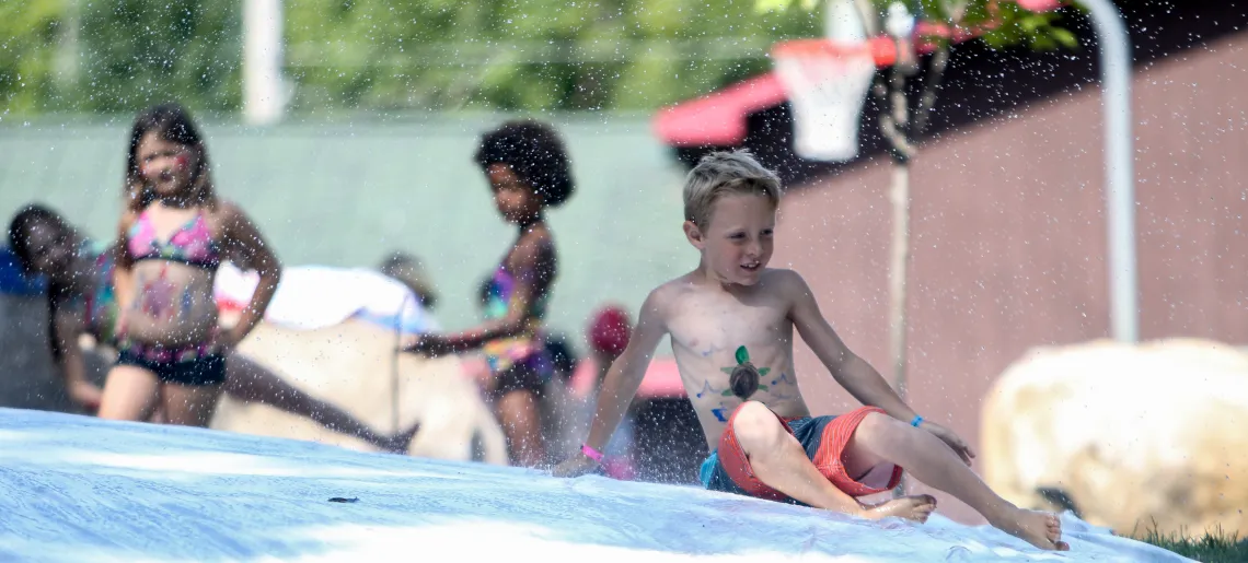 Day Camp children participating in slip and slide water activities