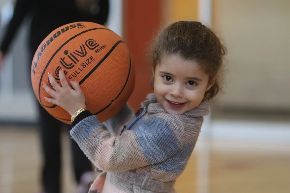 Female child holding a basketball