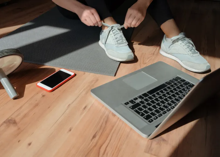 Putting on shoes to start a vitural workout