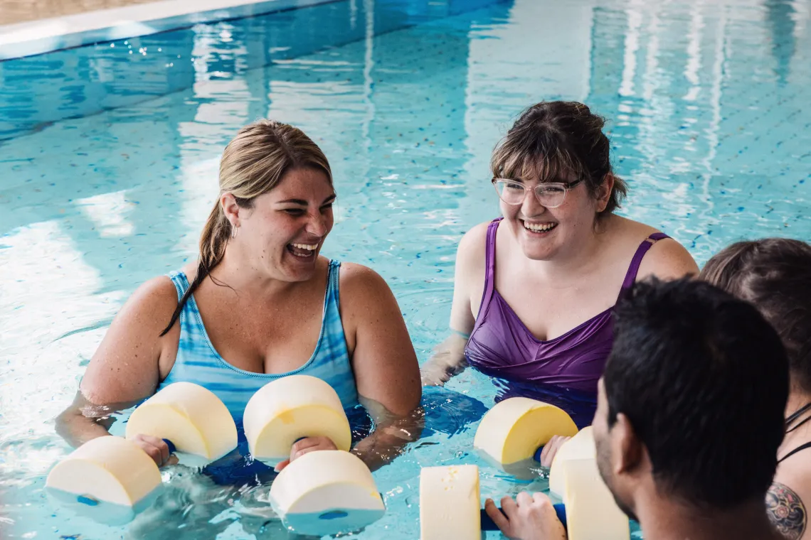 Three women in aquafit class smiling