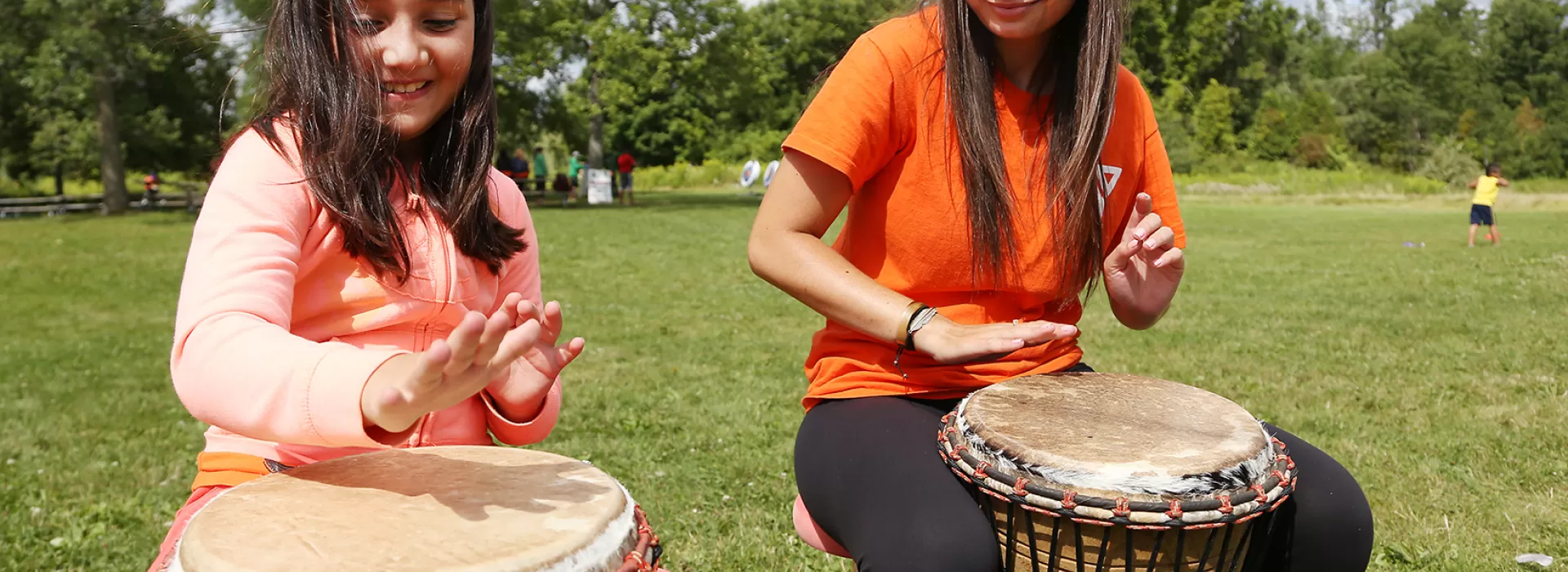 Camper and Counsellor beating on drums