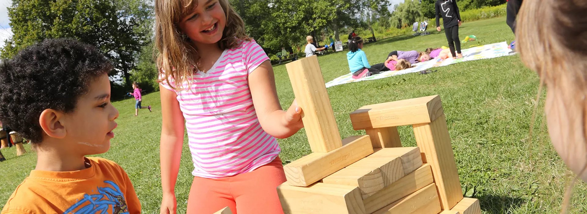 Group of children playing giant Jenga game