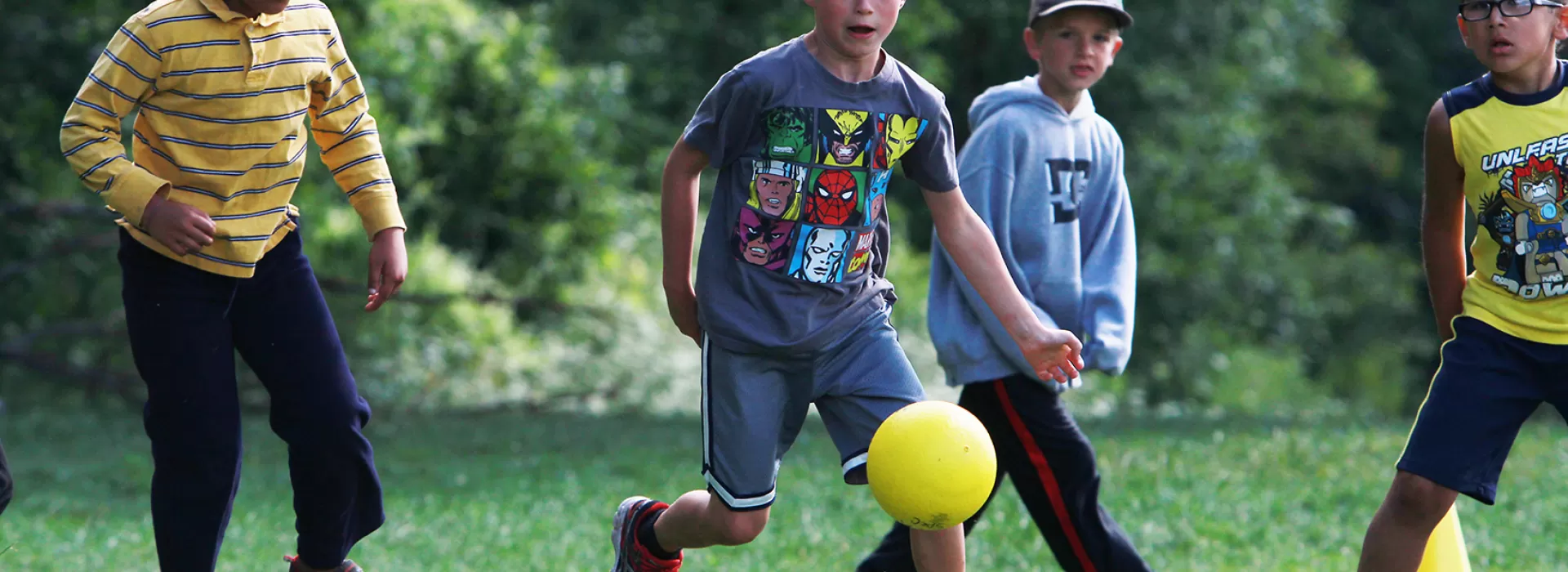 Group of boys playing soccer on grass