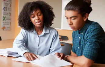 educator and youth studying together