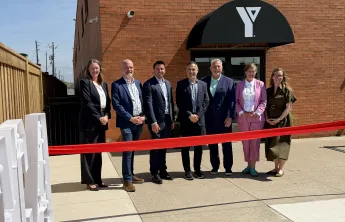 Individuals at ribbon cutting event