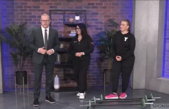 Man and two women in a news segment standing in front of small barbells 