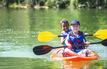 boys in kayak on lake