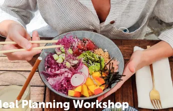 Person eating a bowl with fruits and veggies and fish with chopsticks 