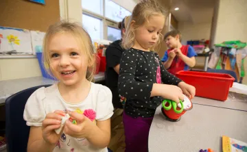 School age girls making crafts