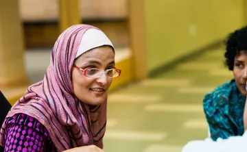 Immigrant woman in group conversation