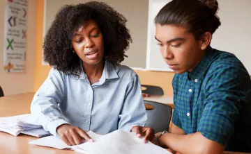 educator and youth studying together
