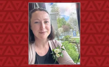 women takes selfie with a flower in her shirt pocket