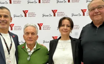 3 men and 1 women pose for photo