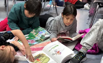 Kids in after school program lay on floor and read books