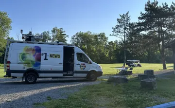 Photo of a CHCH news van at camp 