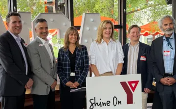 Group of people at event in front of YMCA logo