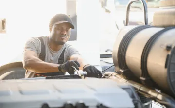 Man working on an undetermined truck part