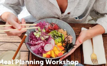 Person eating a bowl with fruits and veggies and fish with chopsticks 