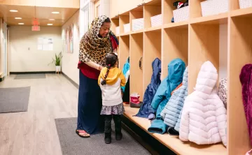 Woman and Child Near Coat Cubbies 